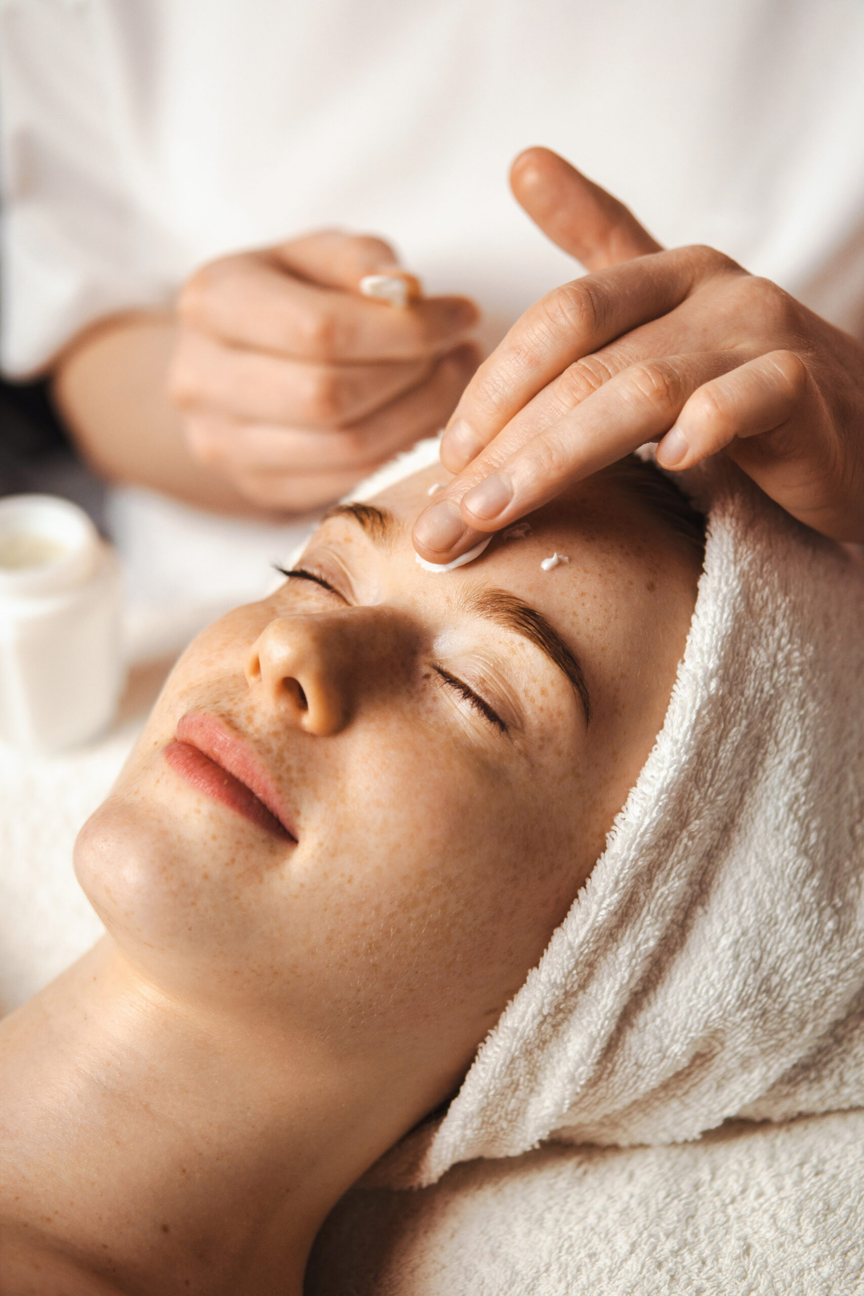 A woman having her facial treatment to prevent the signs of aging.